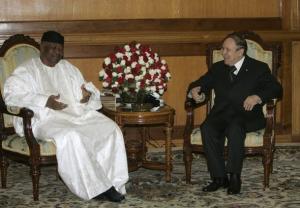Algeria's President Abdelaziz Bouteflika (R) talks to his Malian