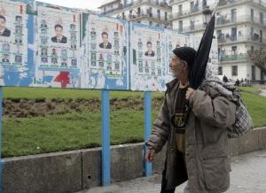 An Algerian man looks at municipal electoral posters in