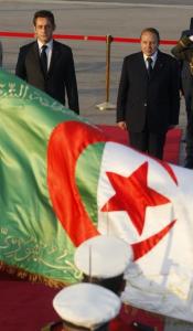 France's President Nicolas Sarkozy (L) is welcomed by Algeria's