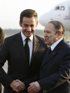 Algeria's President Abdelaziz Bouteflika (R) shakes hands with his