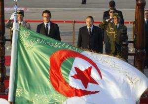 France's President Nicolas Sarkozy (L) is welcomed by Algeria's