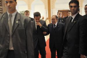 France's President Nicolas Sarkozy (C, left) is escorted by