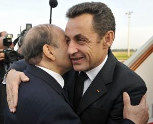 France's President Nicolas Sarkozy (R) embraces Algeria's President Abdelaziz