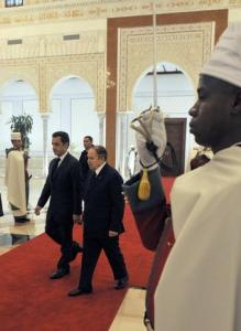 France's President Nicolas Sarkozy (L) walks with Algeria's President