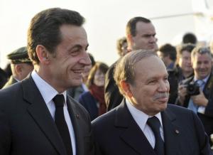 France's President Nicolas Sarkozy (L) stands with Algeria's President