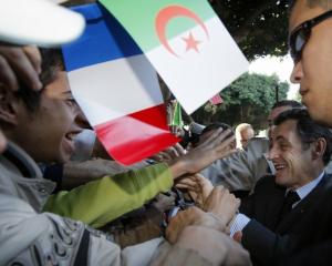 Algerians greet 04 December 2007 French President Nicolas Sarkozy