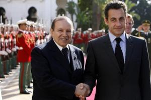 Algeria's Abdelaziz Bouteflika (L) shakes hands with his French