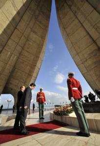 France's President Nicolas Sarkozy (2nd L) pays his respects