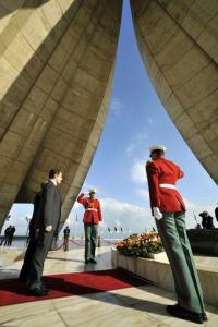 French President Nicolas Sarkozy (2nd L) pays respect at