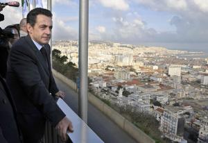 French President Nicolas Sarkozy watches the town of Algiers
