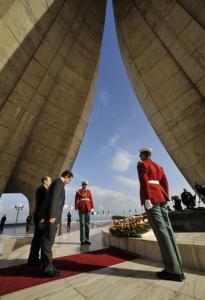 French President Nicolas Sarkozy (2nd L) pays respect at