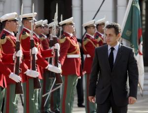 French President Nicolas Sarkozy reviews an honor guard upon