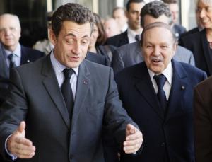 France's President Nicolas Sarkozy (L) speaks with Algeria's President