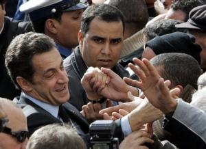 French President Nicolas Sarkozy shakes hand with well wishers