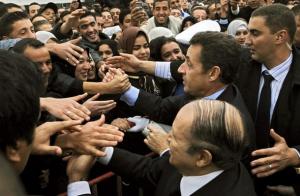 French President Nicolas Sarkozy (2ndL) shakes hand with students