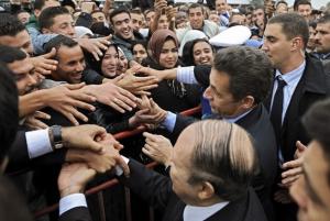 French President Nicolas Sarkozy (2ndL) shakes hand with students