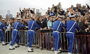Students wave as they wait Algerian President Abdelaziz Bouteflika