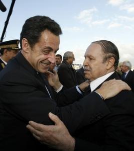 France's President Nicolas Sarkozy (L) hugs his Algerian counterpart