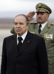 Algeria's President Abdelaziz Bouteflika stands at attention as the