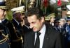 France's President Nicolas Sarkozy walks past military representatives before