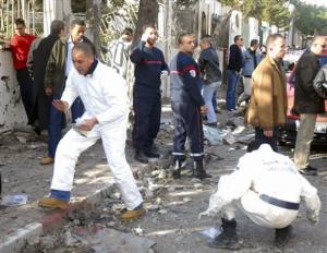 Forensic policemen work at the site of a bomb