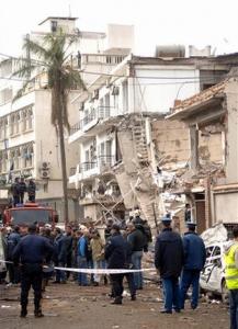 Rescuers work near a destroyed building at the site