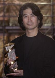 South Korean director Jeon Soo-il (L) holds the golden
