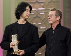 South Korean director Jeon Soo-il (L) holds the golden
