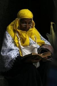 A Muslim woman pilgrim reads the holy Quran in