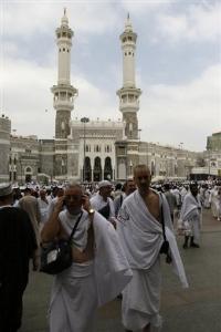 Muslims pilgrims walk outside of the Grand mosque in