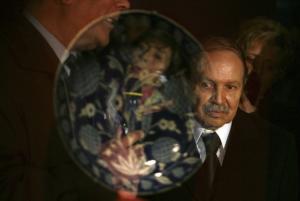 Algeria's President Abdelaziz Bouteflika is seen through a showcase
