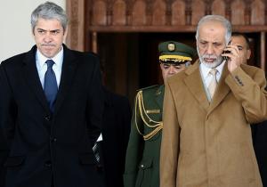 Algeria's Prime Minister Abdelaziz Belkhadem (R) talks on his