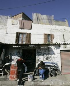 A woman walks in a street of Bourouba, outside