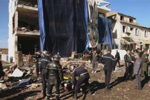 Rescuers and policemen work in front of the seriously