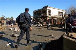 Policemen patrol near a seriously damaged building in Naciria,