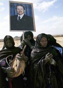 Touareg women, one holding a portrait of Algerian President