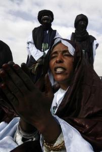 A Tuareg woman claps her hands during the official