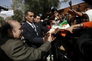 Algeria's President Abdelaziz Bouteflika shakes hands with citizens during