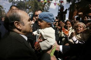 Algeria's President Abdelaziz Bouteflika kisses a baby during his