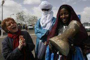 Algeria's Culture Minister Khalida Toumi (L) sings with tuareg