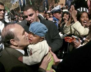 Algerian President Abdelaziz Bouteflika, left, closely escorted by bodyguards,