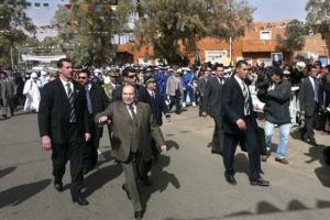 Algerian President Abelaziz Bouteflika, foreground left, closely surrounded by