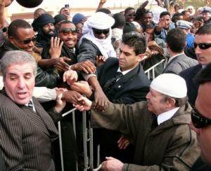 Algerian President Abdelaziz Bouteflika, foreground right, closely escorted by