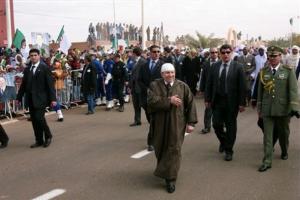 Algerian President Abdelaziz Bouteflika, foreground, closely escorted by bodyguards,