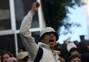 An Algerian secondary school student shouts slogans during a