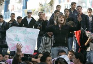 Secondary school students shout slogans during a protest held