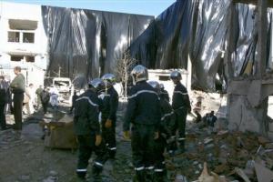Rescuers work by the wrecking of a police station,