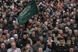 Bosnian Muslims shout slogans during a protest against the