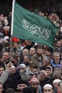 Bosnian Muslims shout slogans during a protest against the