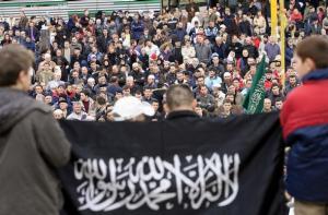 Bosnian Muslims shout slogans during a protest against the